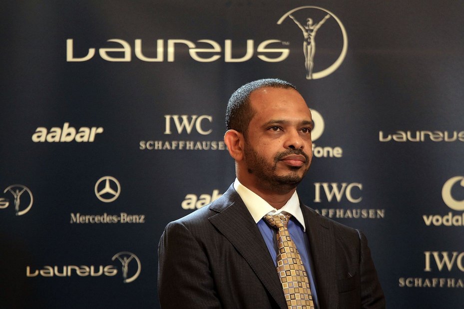 Mohamed al-Husseiny poses in front of Laureus, IWC Schwaffhausen, Mercedez-Benz and Aabar logos