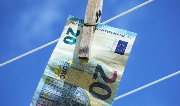 EU bank note hanging on washing line as illustration of money laundering