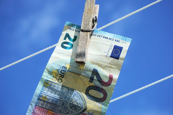 EU bank note hanging on washing line as illustration of money laundering