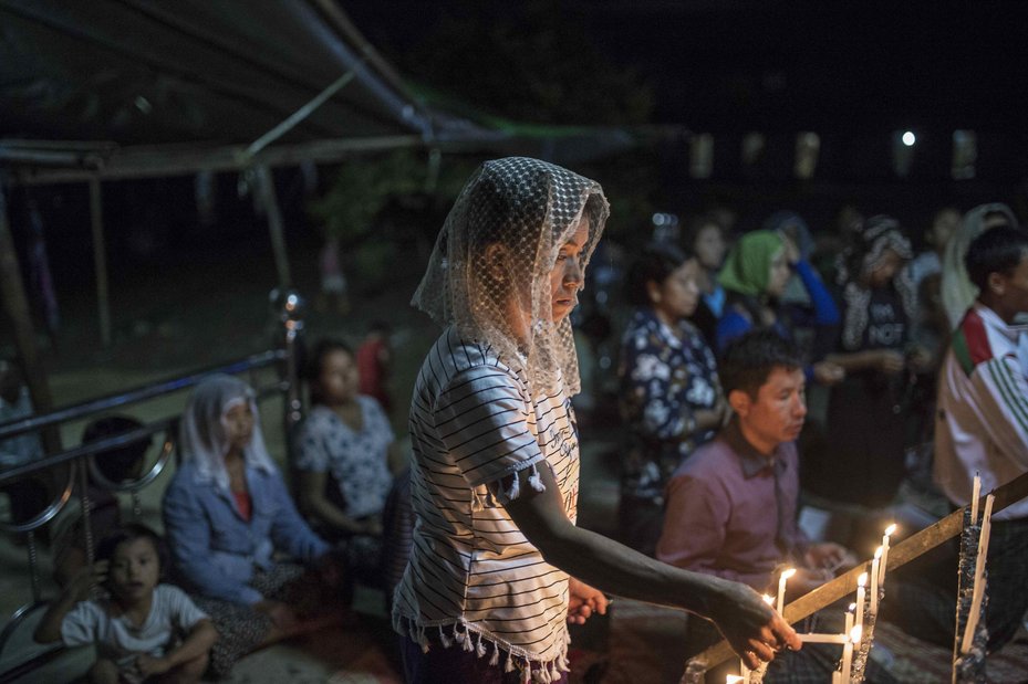 Internally displaced people say prayers in the evening at the Namt Ma-Phyit Roman-Catholic IDP camp which is  home to displaced villagers from villages in and around Hpakant, October 26, 2016.