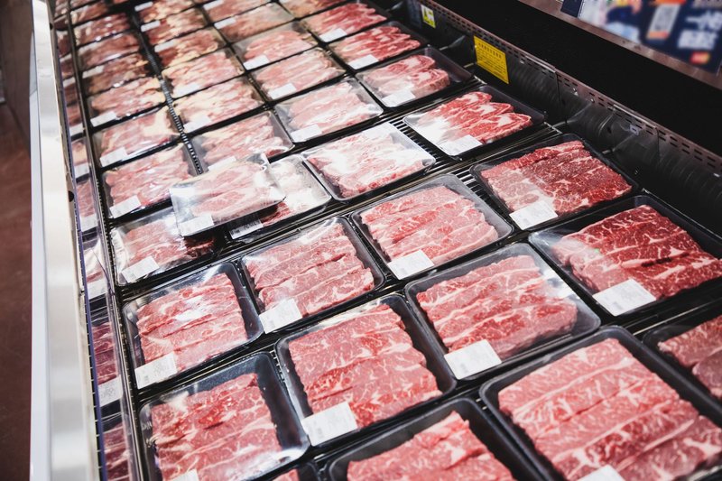 packaged meat on counter at supermarket