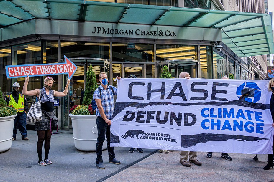 Participants holding a banner that reads "Chase Defund Climate Change" at the JPMorgan Chase protest, New York