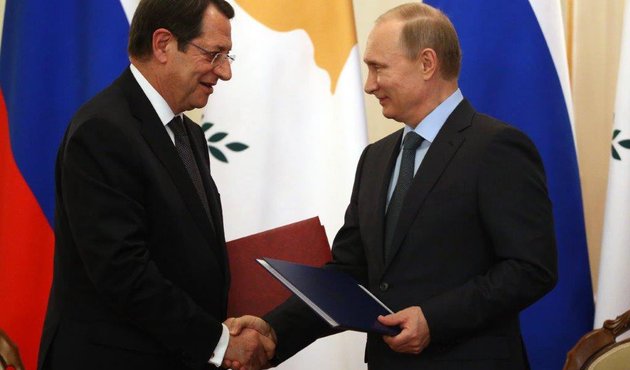 Cyprus President Nicos Anastasiades shakes hands with Valdimir Putin