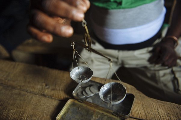 Matandiko Birindwa (45) holds a set of weighing scales that he uses to trade gold, pictured in the village of Mufa II in South Kivu, in the east of the Democratic Republic of the Congo on April 11, 2015.