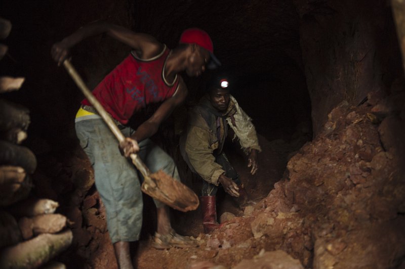 Artisanal miners dig a tunnel of a cassiterite mine