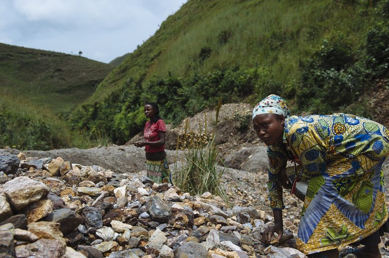 Riziki Jerome (25, right) is pictured as she searches for cassiterite amongst rock detritus at the D23 mining site in South Kivu province, in the east of the Democratic Republic of the Congo on April 4, 2015.