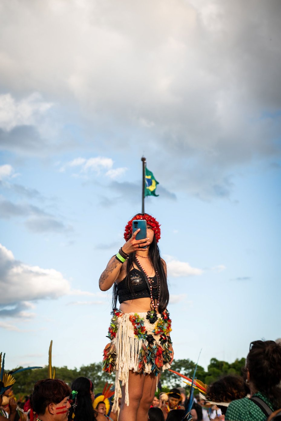 An Indigenous person documents the Acampamento Terra Livre (Free Land Camp) on a smartphone in Brasilia, Brazil