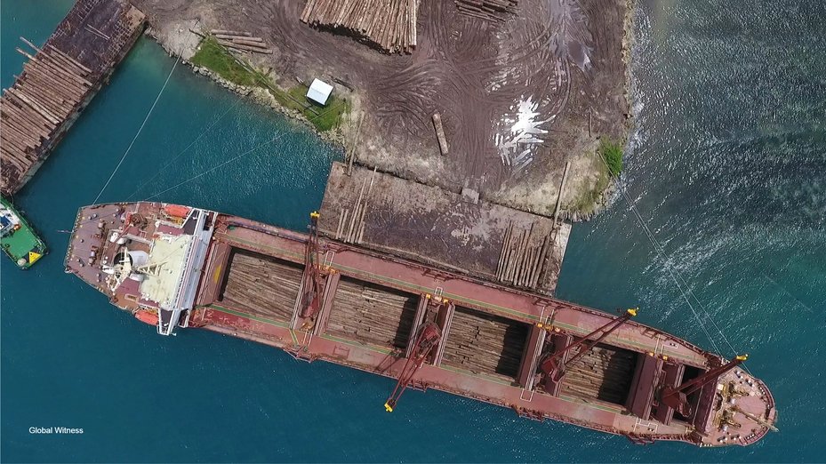 Drone footage of logs being loaded onto a cargo ship in Papua New Guinea