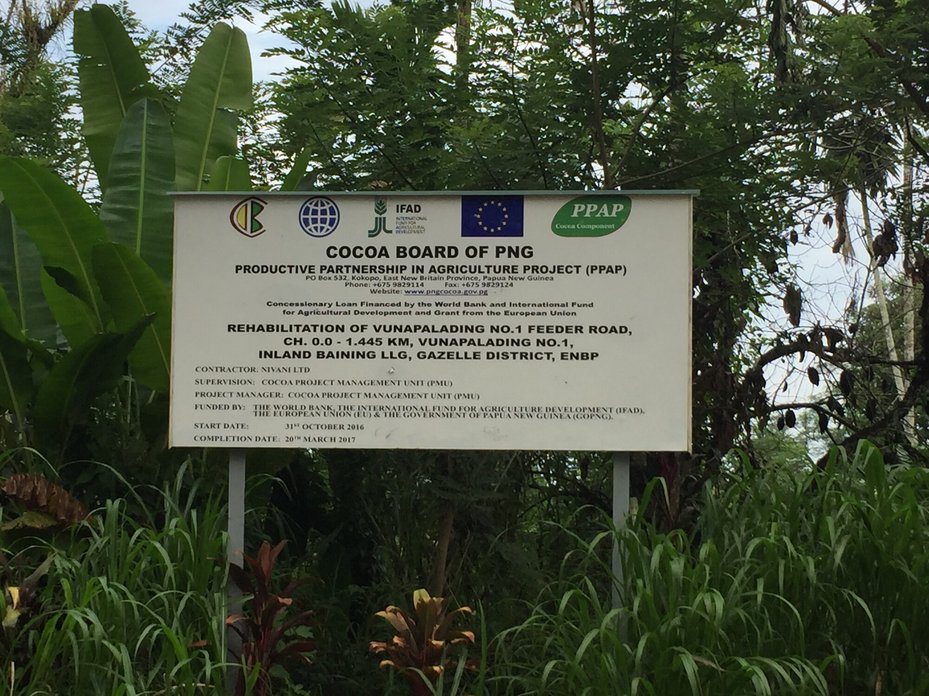 Roadside sign describes a project under the World Bank-funded Productive Partnership in Agriculture Project, East New Britain Province, Papua New Guinea