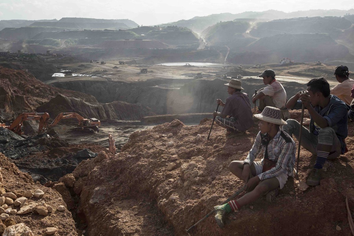 Freelance Yemasae miners sit on top of a hill near the Ngo Pin