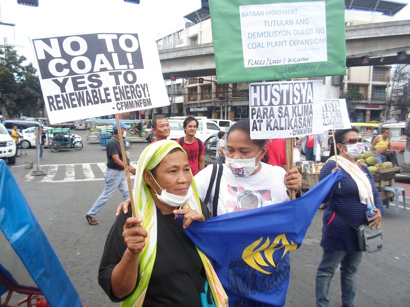 Ate Gloria and Derek Cabe march for climate justice in Manila, Philippines.