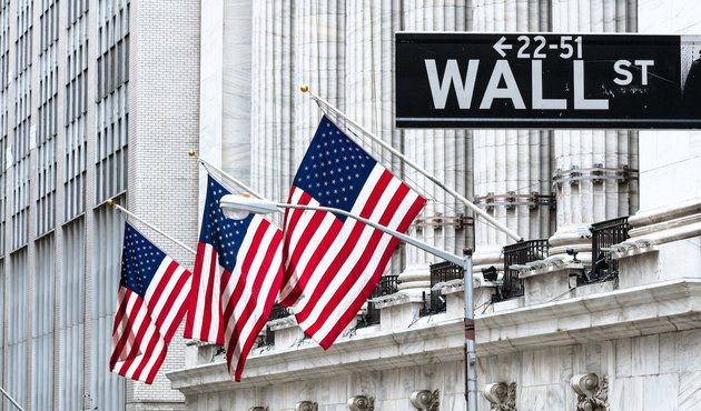 US flags flutter on Wall Street, New York