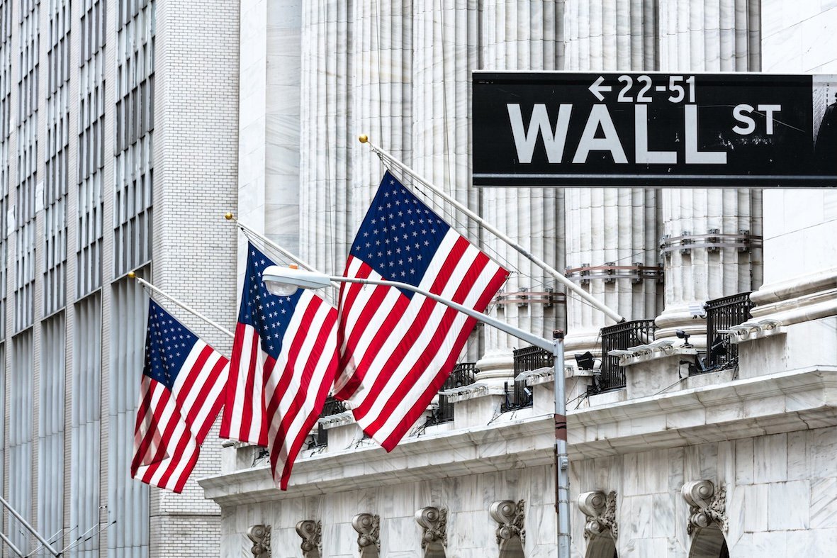 US flags flutter on Wall Street, New York