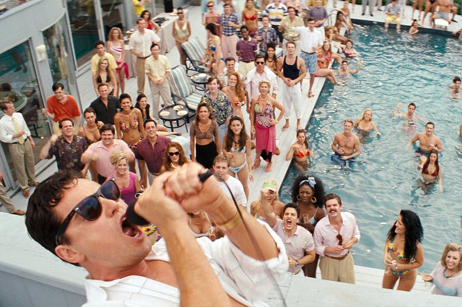 Leondardo DiCaprio shouts into microphone from roof in The Wolf of Wall Street