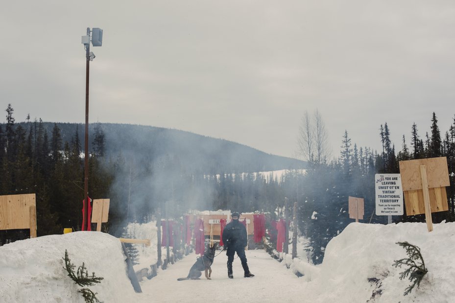 An RCMP officer stands near the Morice River bridge, Canada