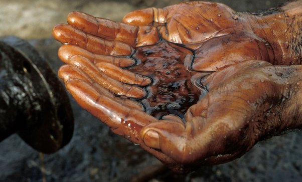 A photograph of a pair of hands, cupped, holding oil