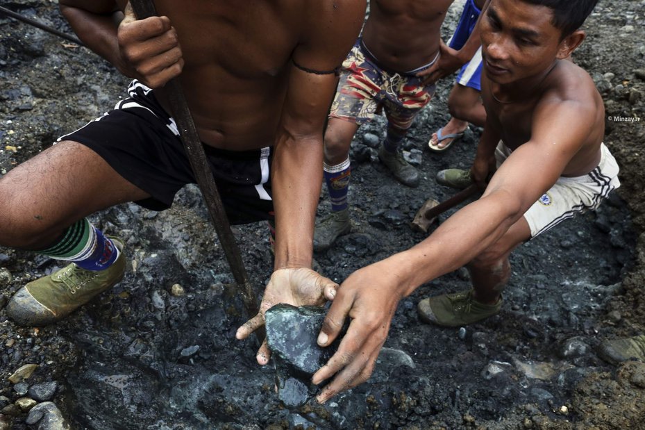 Jade miners holding raw jade