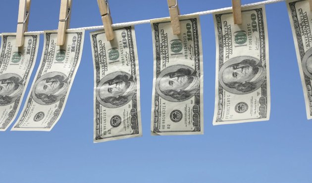 money laundering illustration, dollar notes on washing line