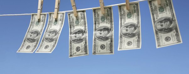 money laundering illustration, dollar notes on washing line