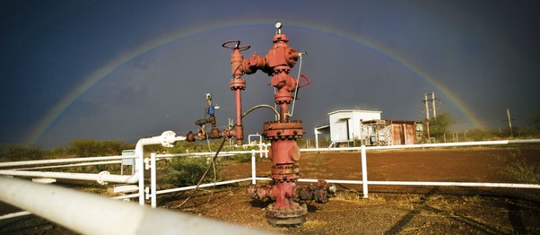 Oil field with a rainbow in the background