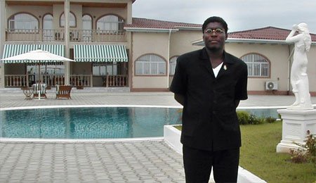 Teodorin Obiang, son of the dictator of oil-rich Equatorial Guinea, poses in front of lavish house