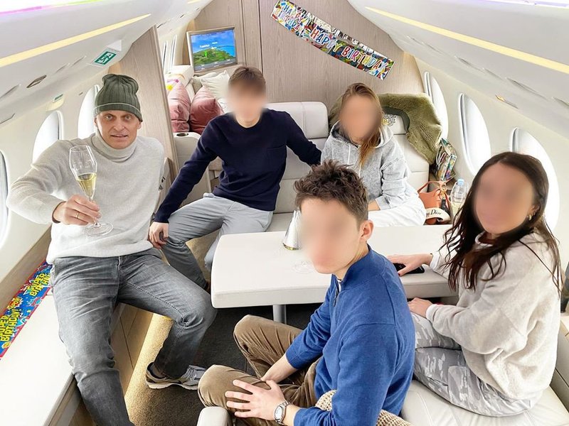 The Tinkov family in the cabin of what appears to be a private jet